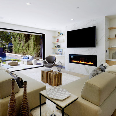 Inspiration for a contemporary light wood floor and beige floor living room remodel in Los Angeles with white walls, a ribbon fireplace, a stone fireplace and a wall-mounted tv
