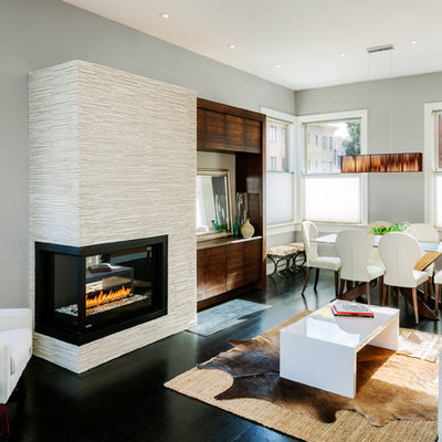 Living room - contemporary formal and open concept dark wood floor and black floor living room idea in San Francisco with a two-sided fireplace, gray walls, a tile fireplace and a media wall