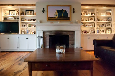 Foto de salón abierto tradicional con paredes blancas, suelo de madera en tonos medios, todas las chimeneas, marco de chimenea de ladrillo y televisor independiente