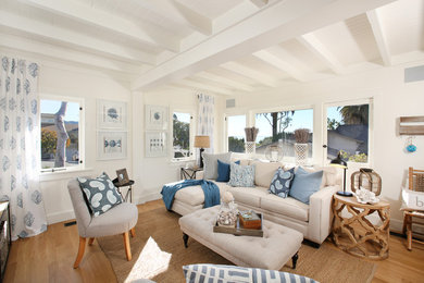 Inspiration for a medium tone wood floor living room remodel in Orange County with white walls
