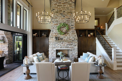 Living room - huge cottage formal and open concept medium tone wood floor and beige floor living room idea in Portland with beige walls, a standard fireplace, a brick fireplace and a concealed tv