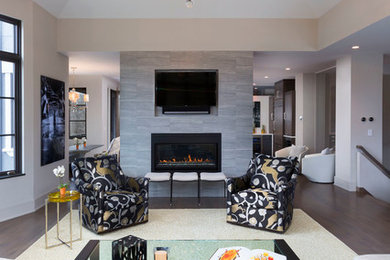 Large trendy formal and open concept dark wood floor and brown floor living room photo in Milwaukee with gray walls, a two-sided fireplace, a tile fireplace and a media wall