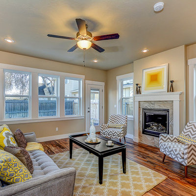 Example of a large transitional formal and enclosed medium tone wood floor and brown floor living room design in Boise with beige walls, a standard fireplace, no tv and a tile fireplace