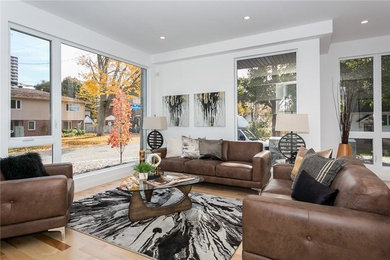 Inspiration for a contemporary light wood floor living room remodel in Toronto with white walls