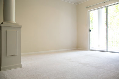 Example of a mid-sized enclosed carpeted living room design in Other with beige walls