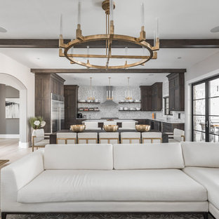 This is an example of a large mediterranean open plan living room in Indianapolis with grey walls, medium hardwood flooring and a wall mounted tv.