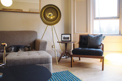 Example of a mid-sized eclectic light wood floor living room design in Glasgow