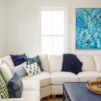 Mid-sized island style open concept light wood floor living room photo in Charleston with white walls and a wall-mounted tv