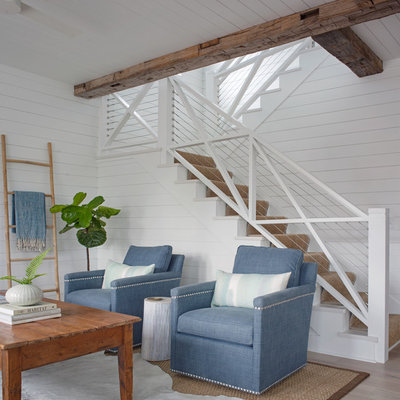 Small beach style open concept light wood floor and brown floor living room photo with white walls and no fireplace
