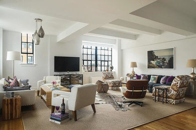 Example of a mid-sized eclectic medium tone wood floor and brown floor living room design in New York with white walls and a wall-mounted tv