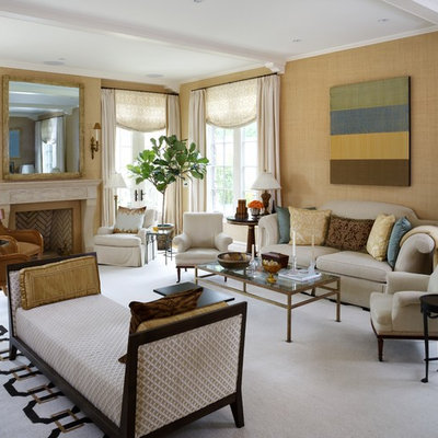 Example of a classic living room design in DC Metro with beige walls, a standard fireplace and no tv