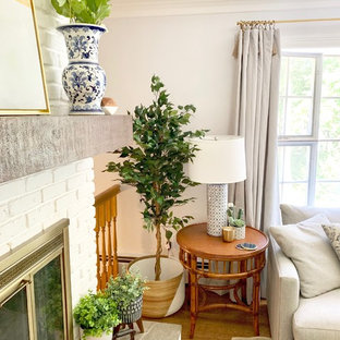 Example of a mid-sized farmhouse enclosed medium tone wood floor and brown floor living room design in New York with a standard fireplace, a brick fireplace, a wall-mounted tv and blue walls