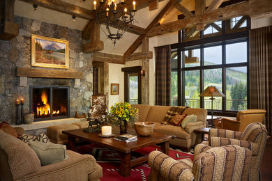 Mountain style living room photo in Denver with a stone fireplace