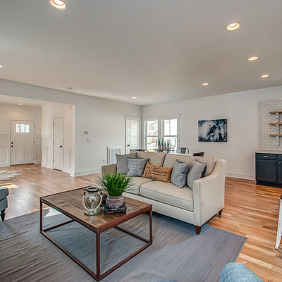Living room - mid-sized cottage open concept light wood floor living room idea in Nashville with white walls