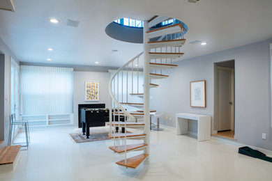 A spiral staircase accents a sparkling white polished concrete overlay