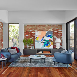 This is an example of a contemporary living room in Perth with white walls, medium hardwood floors and brown floor.