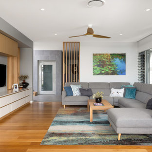 Large contemporary open concept living room in Brisbane with white walls, medium hardwood floors, a built-in media wall, brown floor, exposed beam and no fireplace.