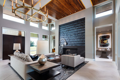 Inspiration for a contemporary enclosed gray floor and wood ceiling living room remodel in Tampa with gray walls, a standard fireplace and a stone fireplace