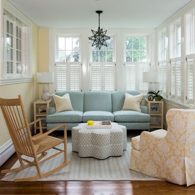 Inspiration for a small timeless open concept medium tone wood floor and brown floor living room remodel in Boston with yellow walls