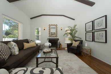 Example of a mid-sized transitional formal and open concept medium tone wood floor living room design in San Diego with white walls, a standard fireplace, a metal fireplace and no tv
