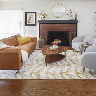 Großes, Offenes Retro Wohnzimmer mit weißer Wandfarbe, braunem Holzboden, Kamin, Kaminumrandung aus Stein und braunem Boden in San Francisco