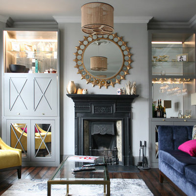 Inspiration for a small transitional enclosed dark wood floor and brown floor living room remodel in London with gray walls, a standard fireplace and a metal fireplace