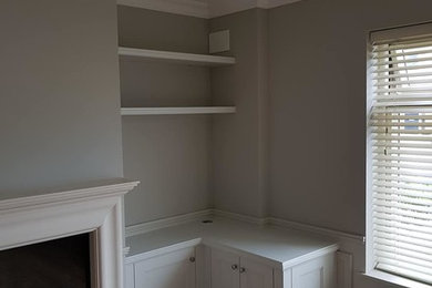 Alcove base units one L shaped to accommodate tv and floating shelving above.li