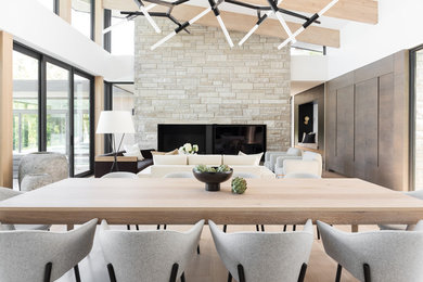 Inspiration for a mid-century modern open concept light wood floor and beige floor living room remodel in Minneapolis with white walls, a standard fireplace and a stone fireplace