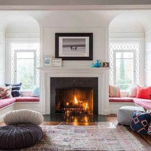 Foto de salón abierto, clásico renovado, grande, con paredes blancas, suelo de madera oscura, todas las chimeneas y marco de chimenea de baldosas y/o azulejos