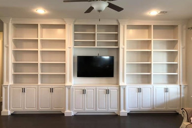 Photo of a large formal enclosed living room in Houston with a built-in media unit.