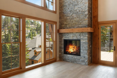 Example of a large transitional formal and open concept light wood floor and beige floor living room design in Other with white walls, a standard fireplace and a stone fireplace
