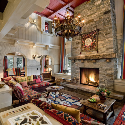 Large mountain style formal and enclosed dark wood floor and brown floor living room photo in San Francisco with a standard fireplace, a stone fireplace, gray walls and no tv