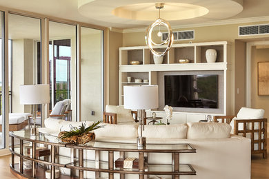 Inspiration for a transitional open concept medium tone wood floor and brown floor living room remodel in Miami with beige walls and a wall-mounted tv