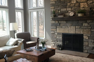 Living room - craftsman living room idea in Grand Rapids with a stone fireplace