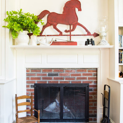 Example of a mid-sized farmhouse formal and enclosed carpeted living room design in Boston with white walls, a standard fireplace, a brick fireplace and a tv stand