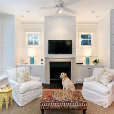 Mid-sized beach style enclosed medium tone wood floor living room photo in San Francisco with white walls and a wall-mounted tv