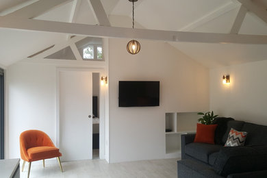Inspiration for a medium sized modern living room in Berkshire with white walls, ceramic flooring and a wall mounted tv.
