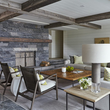 Another living space with white panelling and added beams of wood across ceiling