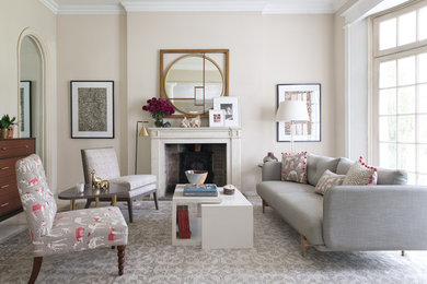 Design ideas for a traditional formal living room in London with beige walls, a standard fireplace and no tv.