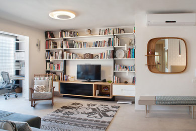 Living room library - small contemporary open concept travertine floor living room library idea in Tel Aviv with white walls and no tv