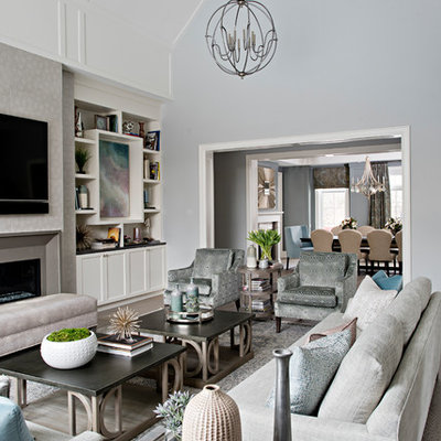 Inspiration for a large timeless enclosed medium tone wood floor and brown floor living room remodel in Toronto with gray walls, a standard fireplace, a tile fireplace and a wall-mounted tv
