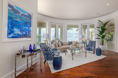 Example of a large beach style open concept light wood floor and brown floor living room design in Tampa with white walls, no fireplace and no tv