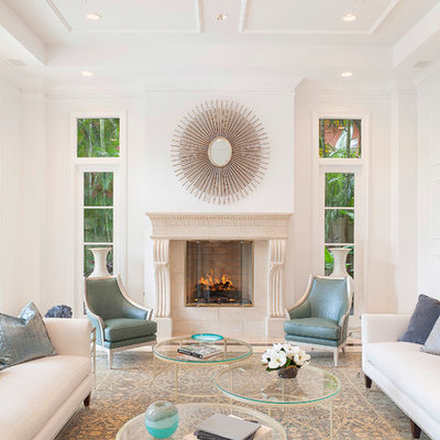 Inspiration for a transitional formal living room remodel in Miami with white walls and a standard fireplace