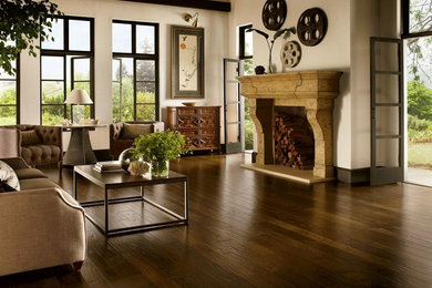 Mid-sized mountain style formal and open concept dark wood floor living room photo in Chicago with beige walls, a standard fireplace, a stone fireplace and no tv
