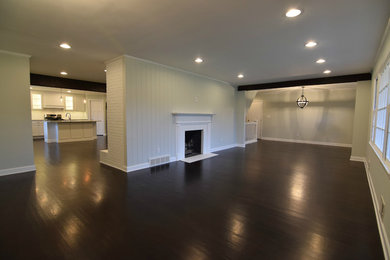 Example of a transitional dark wood floor and brown floor living room design in Indianapolis with a two-sided fireplace and a brick fireplace