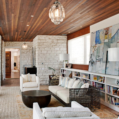 Living room library - contemporary brick floor living room library idea in Austin