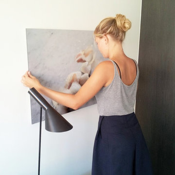 Artist Julie Bjarnhoff installing her photograph
