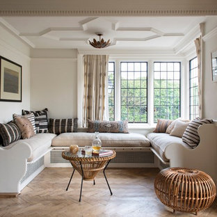 This is an example of a classic formal living room in Berkshire with white walls, light hardwood flooring, no tv and beige floors.