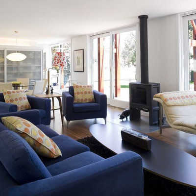 Living room - modern bamboo floor living room idea in New York with a wood stove