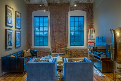 Small trendy loft-style medium tone wood floor living room photo in New York